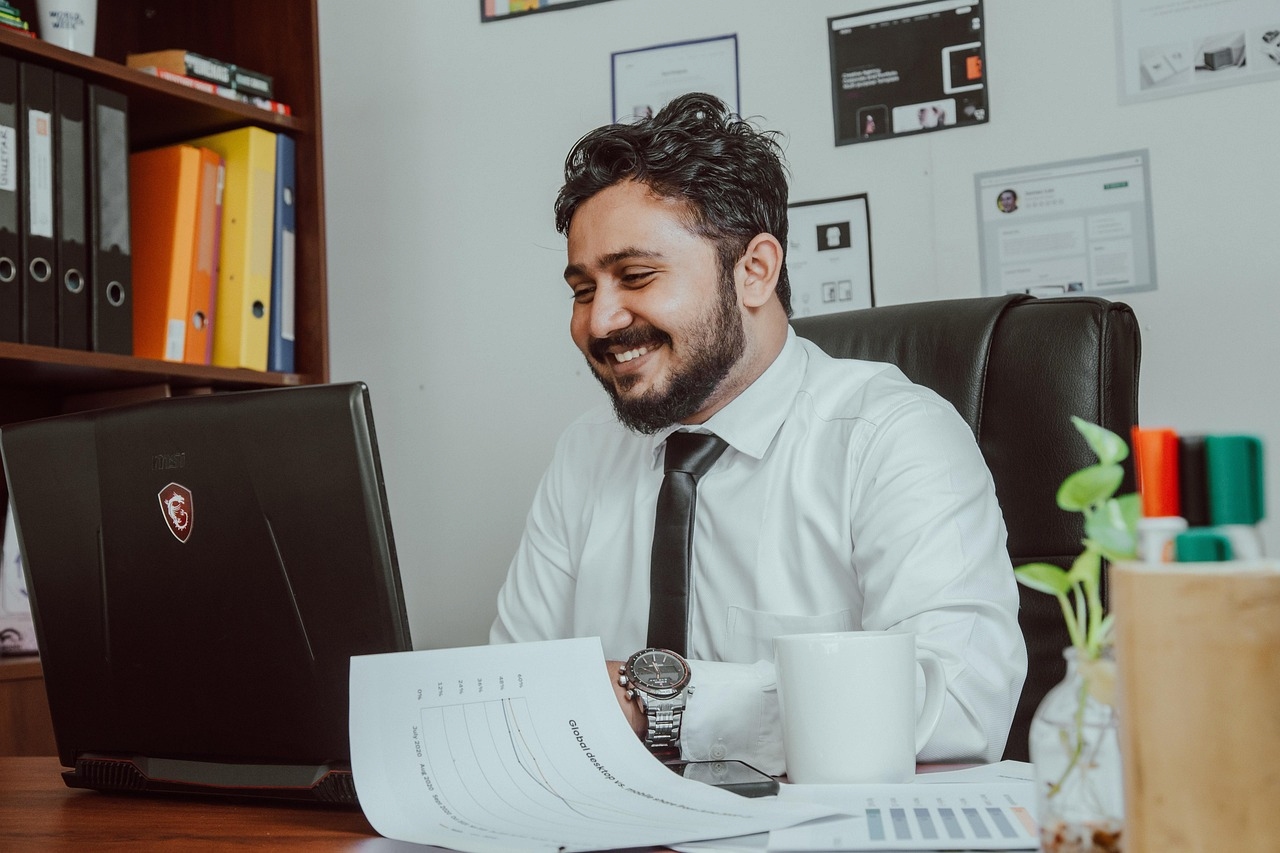 Office manager reviewing financial documents at desk